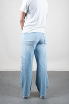 Lola Delicous Wideleg Wide Leg Fit Jeans Light Blue Denim Light Spring Summer. Model wears a Lola in the wash Delicious. It's a wide leg fit. Middle waist height. Premium denim. Comfortable denim. Comfortable jeans. All day wear.