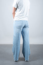 Lola Delicous Wideleg Wide Leg Fit Jeans Light Blue Denim Light Spring Summer. Model wears a Lola in the wash Delicious. It's a wide leg fit. Middle waist height. Premium denim. Comfortable denim. Comfortable jeans. All day wear.